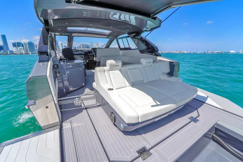  Yacht Photos Pics 2023 Cruisers Yachts 42 GLS OB luxury boat with spacious deck and seating on blue water.