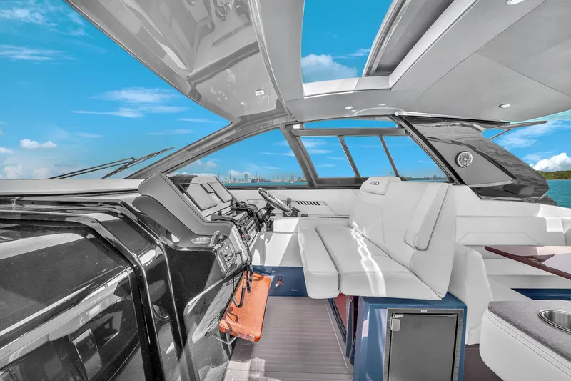  Yacht Photos Pics 2023 Cruisers Yachts 42 GLS OB interior with modern helm and seating, under clear blue skies.