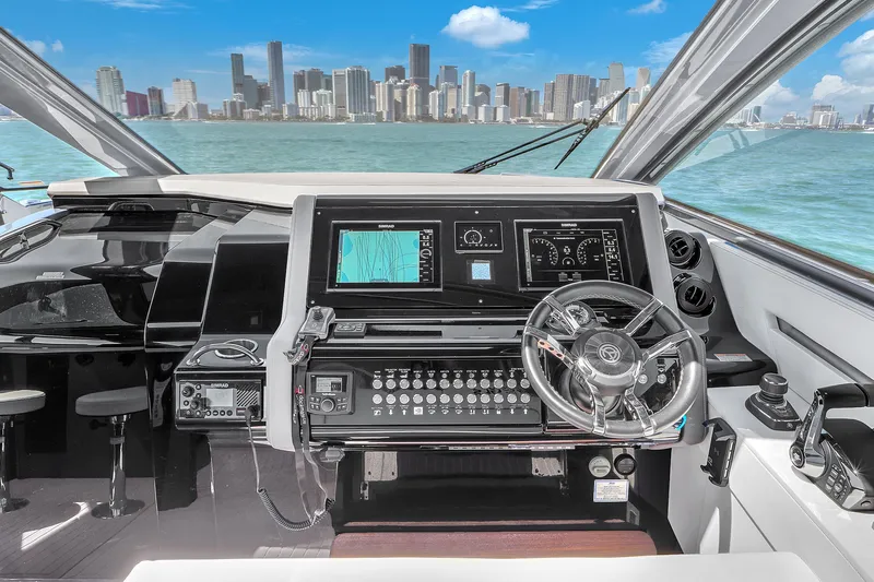  Yacht Photos Pics 2023 Cruisers Yachts 42 GLS OB helm with city skyline in background.