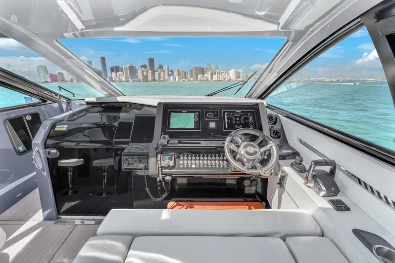  Yacht Photos Pics 2023 Cruisers Yachts 42 GLS OB interior with modern helm and city skyline view.