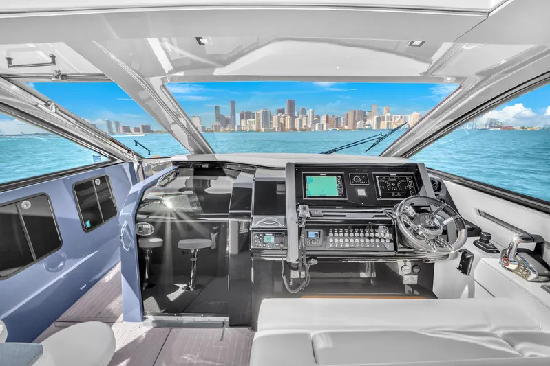  Yacht Photos Pics 2023 Cruisers Yachts 42 GLS OB helm with city skyline view.