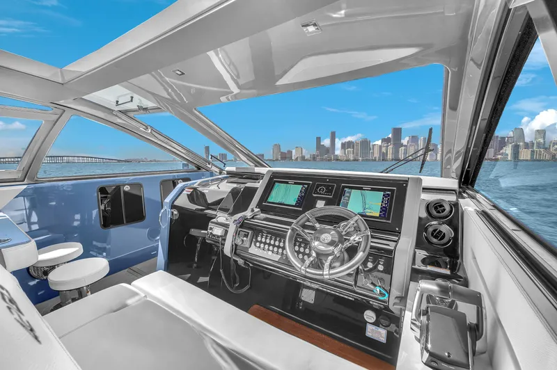  Yacht Photos Pics 2023 Cruisers Yachts 42 GLS OB helm with city skyline view.