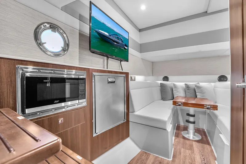  Yacht Photos Pics 2023 Cruisers Yachts 42 GLS OB interior with modern seating, TV, and kitchenette.