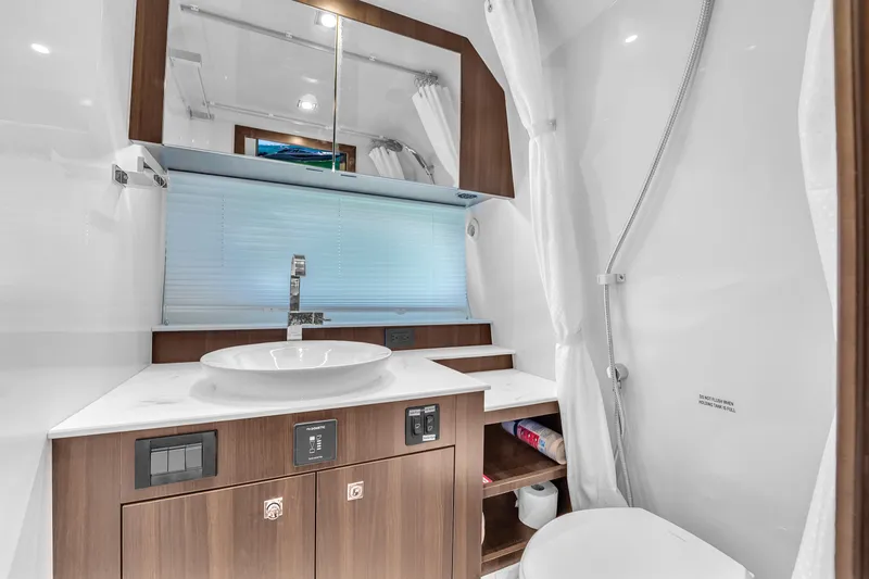  Yacht Photos Pics Luxurious bathroom in 2023 Cruisers Yachts 42 GLS OB with modern fixtures and wood accents.