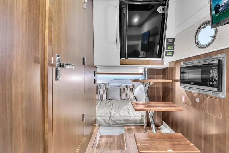  Yacht Photos Pics Interior of 2023 Cruisers Yachts 42 GLS OB, featuring modern wood finishes and cozy sleeping area.