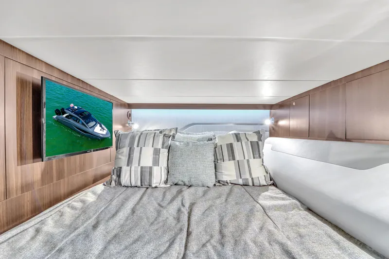  Yacht Photos Pics Luxurious cabin interior of 2023 Cruisers Yachts 42 GLS OB with cozy bedding and TV.