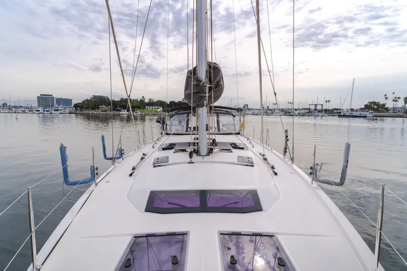 Sacha Marie Yacht Photos Pics 2024 Dufour 470 sailboat docked in a calm marina, showcasing sleek deck design.