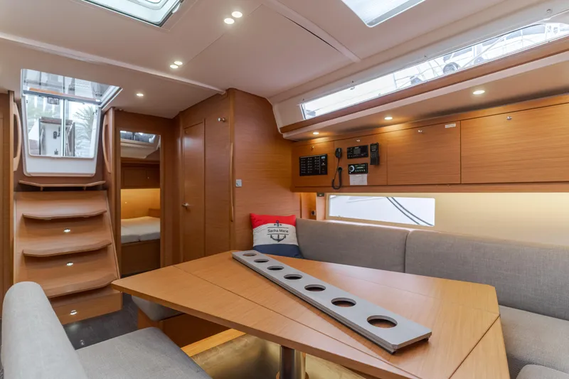 Sacha Marie Yacht Photos Pics 2024 Dufour 470 yacht interior with modern wood finish and cozy seating area.