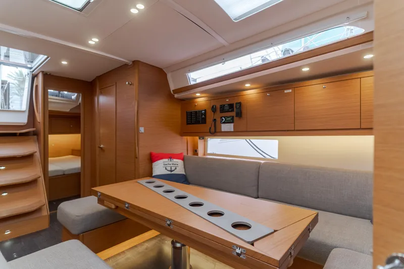 Sacha Marie Yacht Photos Pics 2024 Dufour 470 yacht interior with modern wood finish and cozy seating area.