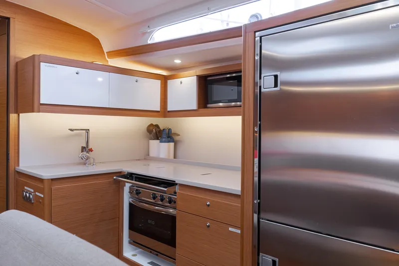 Sacha Marie Yacht Photos Pics Modern kitchen interior of 2024 Dufour 470 yacht with sleek appliances and wood finish.