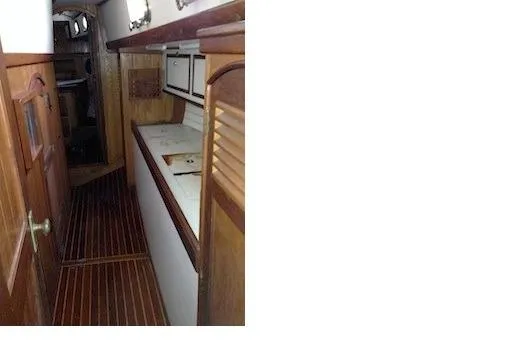 Shamrock Yacht Photos Pics Port passageway to aft cabin featuring workshop area.