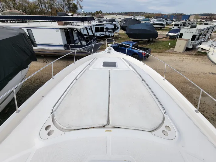  Yacht Photos Pics 2000 Sea Ray 460 Sundancer yacht in a marina with other boats.