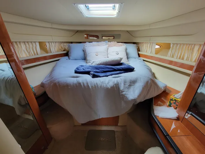  Yacht Photos Pics Cozy bedroom in 2000 Sea Ray 460 Sundancer yacht with skylight and plush bedding.