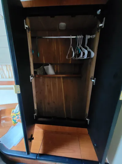  Yacht Photos Pics Empty wooden closet with hangers inside a 2000 Sea Ray 460 Sundancer yacht.