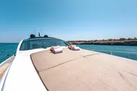 Luxurious 2009 Pershing 72' yacht with sunbathing deck, ocean view, and clear blue sky.
