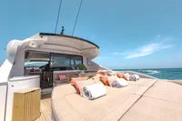 Luxurious 2009 Pershing 72' yacht with sunbathing deck and ocean view.