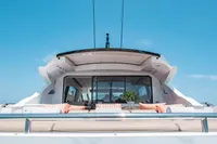 Luxury 2009 Pershing 72' yacht with elegant outdoor seating under clear blue skies.