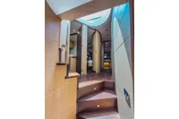 Interior view of 2009 Pershing 72' yacht, featuring elegant wooden staircase and modern design.