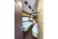 Luxurious twin cabin interior on 2009 Pershing 72' yacht, featuring modern design and cozy bedding.