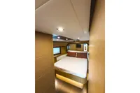 Luxurious bedroom interior of 2009 Pershing 72' yacht with modern design and ambient lighting.