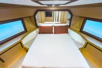 Luxurious bedroom interior of a 2009 Pershing 72' yacht with modern design elements.