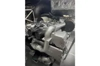 Engine room of a 2009 Pershing 72' yacht, showcasing complex machinery and components.