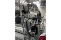 Engine room of a 2009 Pershing 72' yacht, showcasing mechanical components and piping.