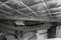 Engine room of a 2009 Pershing 72' yacht with insulated ceiling and visible wiring.