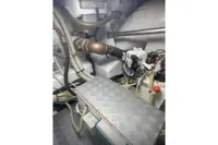 Engine room of a 2009 Pershing 72' yacht with visible pipes and machinery.