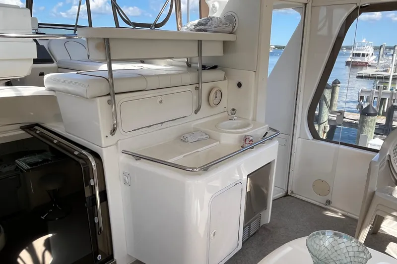  Yacht Photos Pics 1997 Sea Ray 420 Aft Cabin interior with sink and seating, docked at marina.