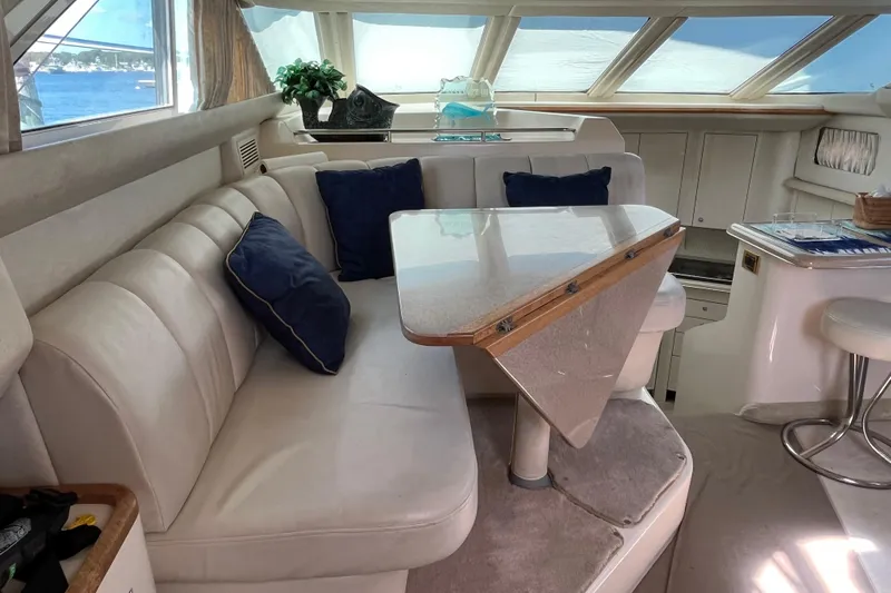  Yacht Photos Pics Luxurious interior of 1997 Sea Ray 420 Aft Cabin yacht with plush seating and elegant decor.
