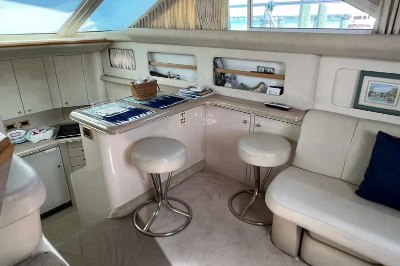  Yacht Photos Pics Luxurious interior of 1997 Sea Ray 420 Aft Cabin yacht with seating and bar area.