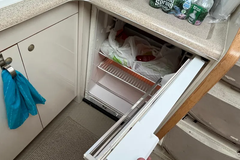  Yacht Photos Pics 1997 Sea Ray 420 Aft Cabin kitchen with open fridge and countertop items.