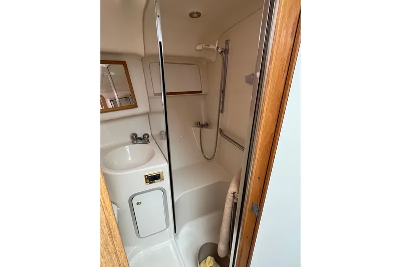  Yacht Photos Pics 1997 Sea Ray 420 Aft Cabin bathroom with shower, sink, and mirror.
