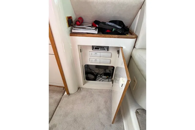  Yacht Photos Pics 1997 Sea Ray 420 Aft Cabin interior storage with open cabinet and electronic equipment.