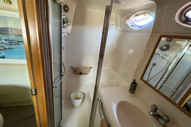  Yacht Photos Pics Bathroom interior of 1997 Sea Ray 420 Aft Cabin yacht, featuring shower and sink.