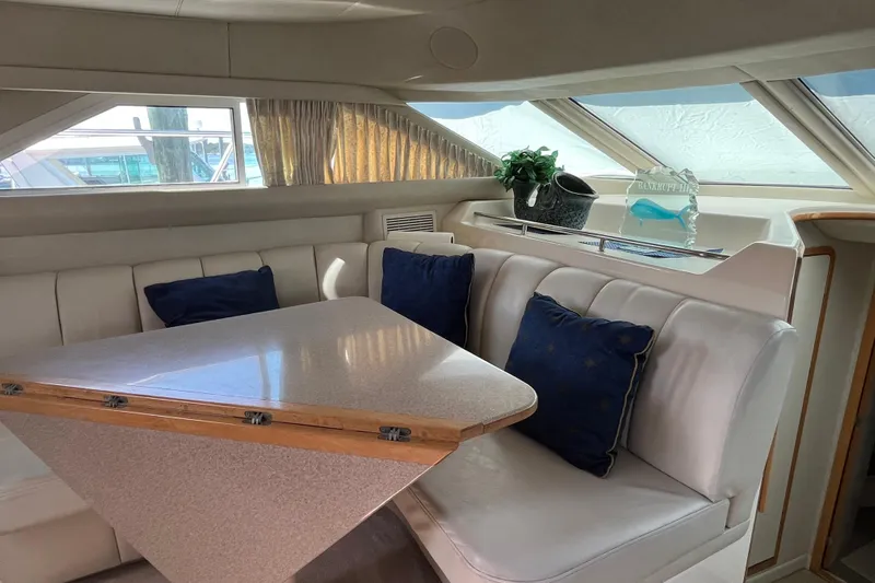  Yacht Photos Pics Interior of 1997 Sea Ray 420 Aft Cabin with dining area and blue cushions.