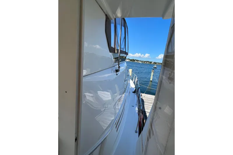  Yacht Photos Pics 1997 Sea Ray 420 Aft Cabin yacht docked by a scenic waterfront.