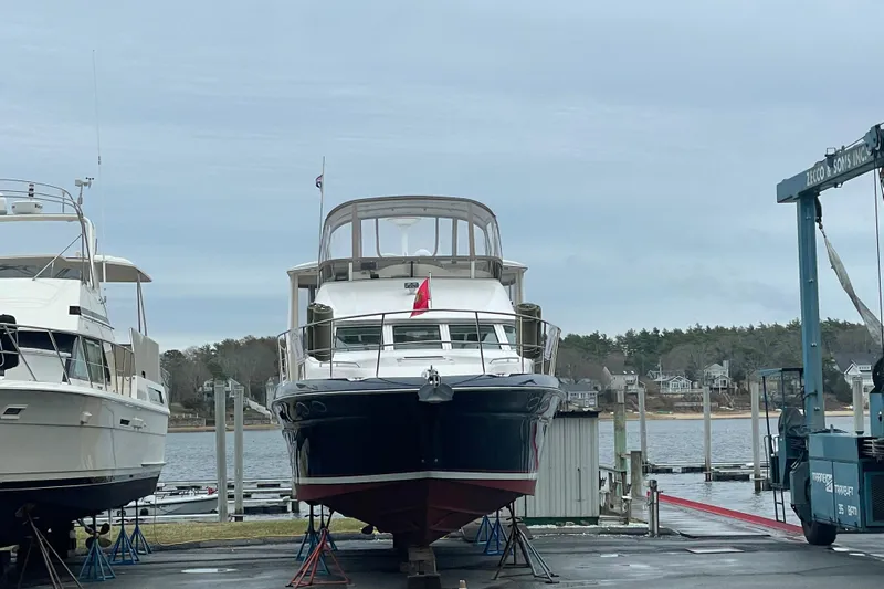  Yacht Photos Pics 1997 Sea Ray 420 Aft Cabin yacht docked at a marina, surrounded by water and trees.
