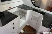 Interior of 1999 Custom Murray Burns Dovell 62 yacht kitchen with sink and storage.