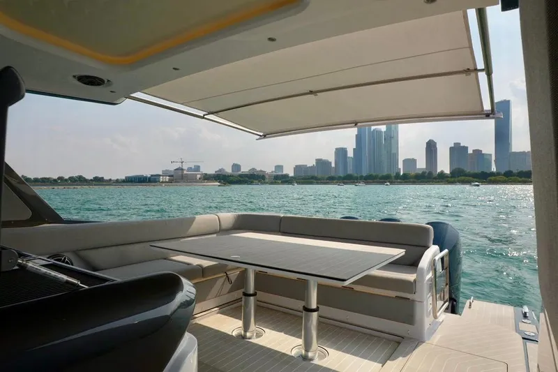  Yacht Photos Pics Luxurious 2024 Azimut Verve 48 yacht with city skyline view and spacious seating area.