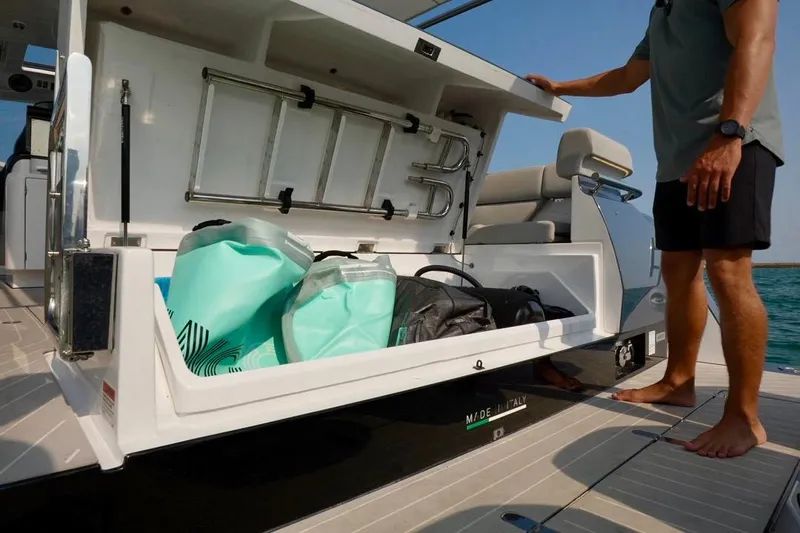  Yacht Photos Pics 2024 Azimut Verve 48 yacht storage compartment with bags and ladder, open on deck.
