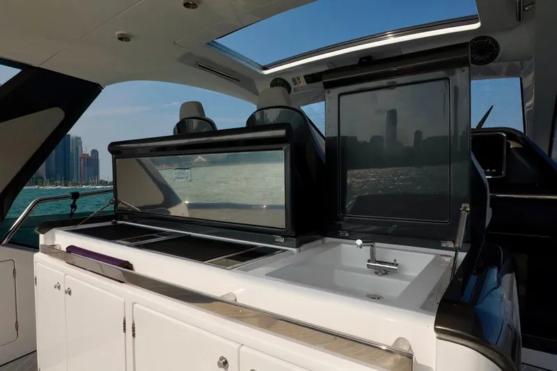  Yacht Photos Pics 2024 Azimut Verve 48 yacht interior with modern kitchenette and city skyline view.