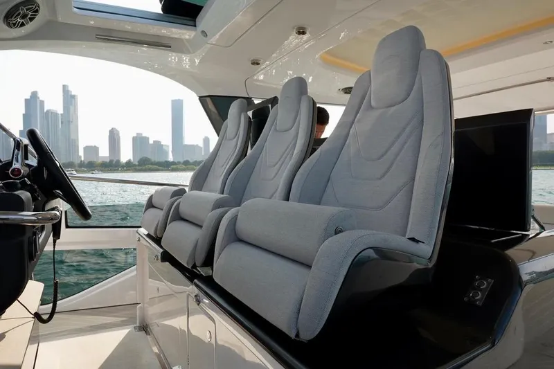  Yacht Photos Pics Luxurious interior of 2024 Azimut Verve 48 yacht with modern seating and city skyline view.