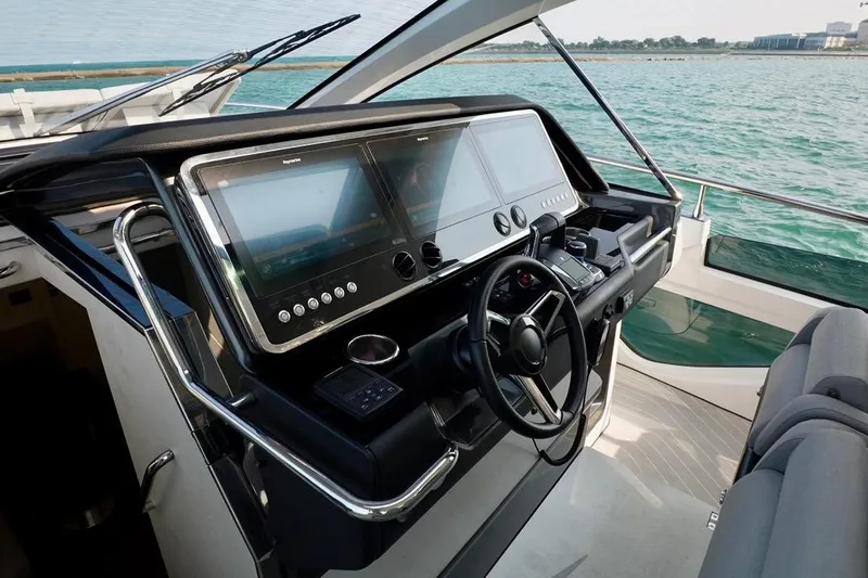  Yacht Photos Pics Helm of 2024 Azimut Verve 48 yacht with dual screens and steering wheel.