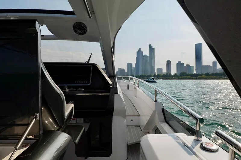  Yacht Photos Pics 2024 Azimut Verve 48 yacht cruising with city skyline in the background.