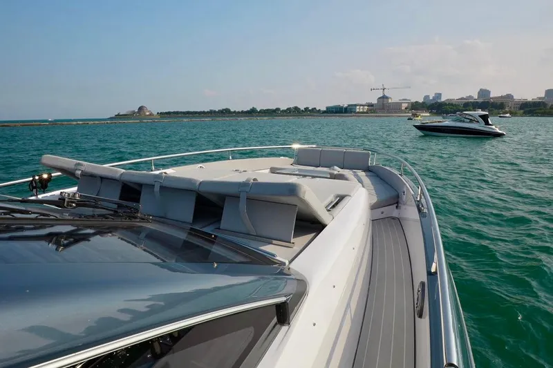  Yacht Photos Pics 2024 Azimut Verve 48 yacht cruising on a scenic, sunny waterfront.