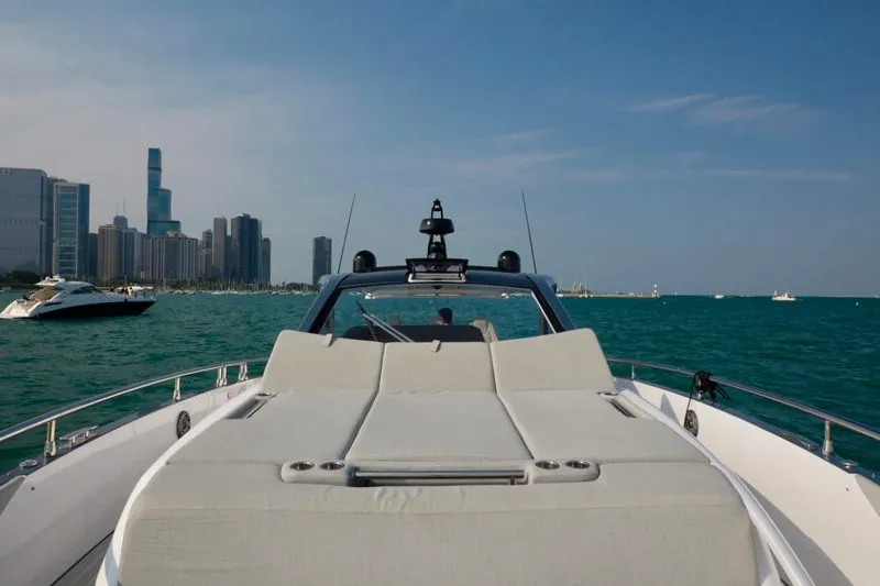  Yacht Photos Pics 2024 Azimut Verve 48 yacht cruising near city skyline on a sunny day.