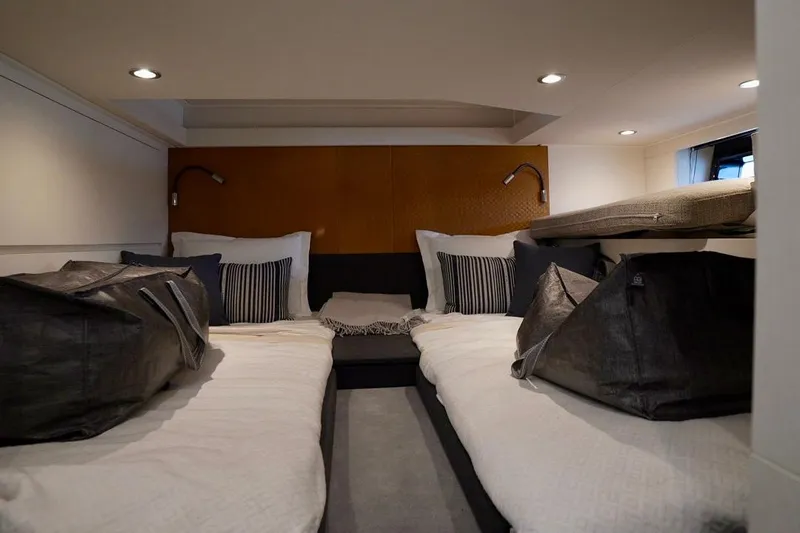  Yacht Photos Pics Luxurious interior cabin of 2024 Azimut Verve 48 yacht with modern bedding and lighting.