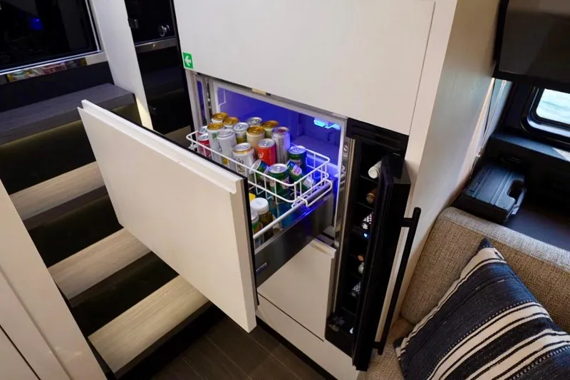  Yacht Photos Pics Mini fridge stocked with beverages on 2024 Azimut Verve 48 yacht interior.